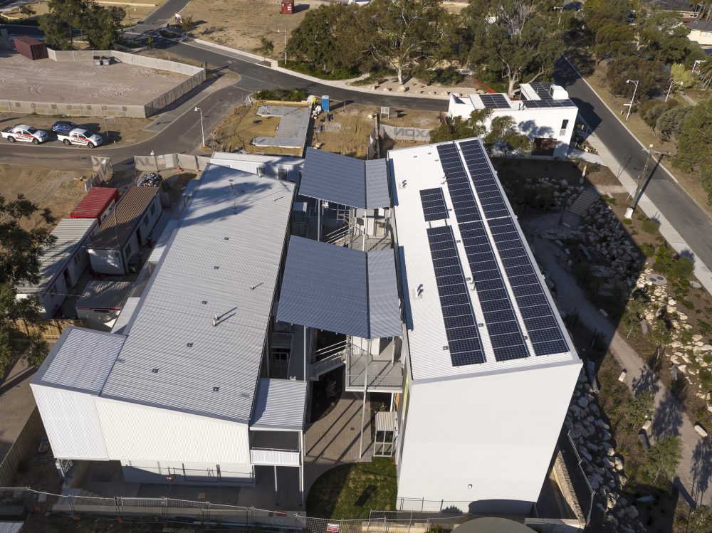 An aerial view of the development shows the rooftop solar panels